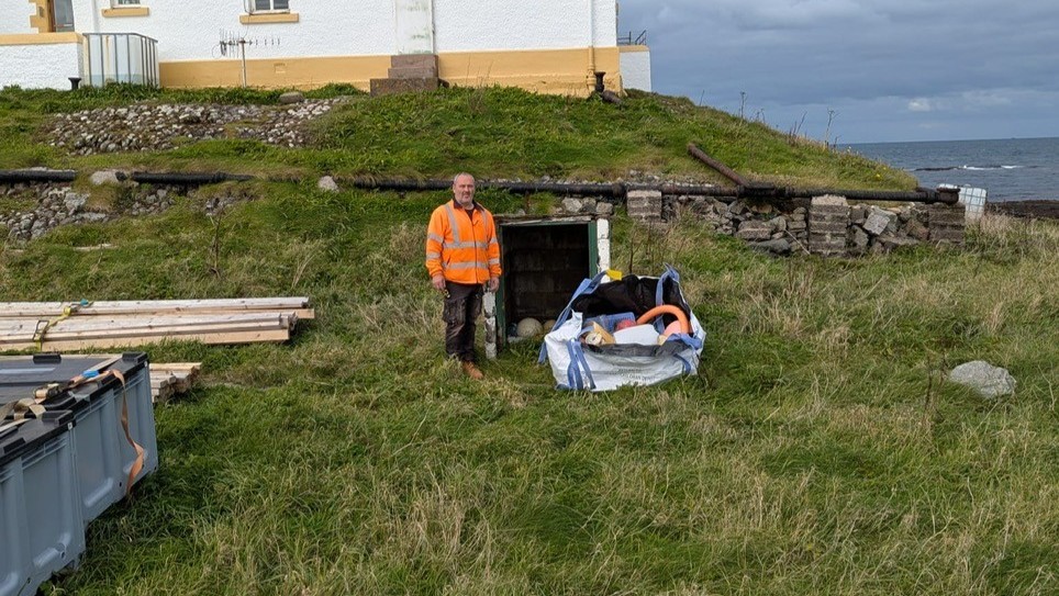 Trac team member outside Hyskeir Lighthouse after litter pick